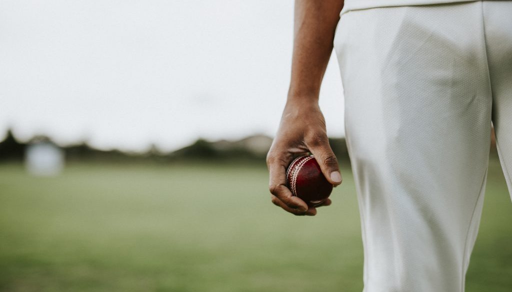 Cricket player holding a leather ball