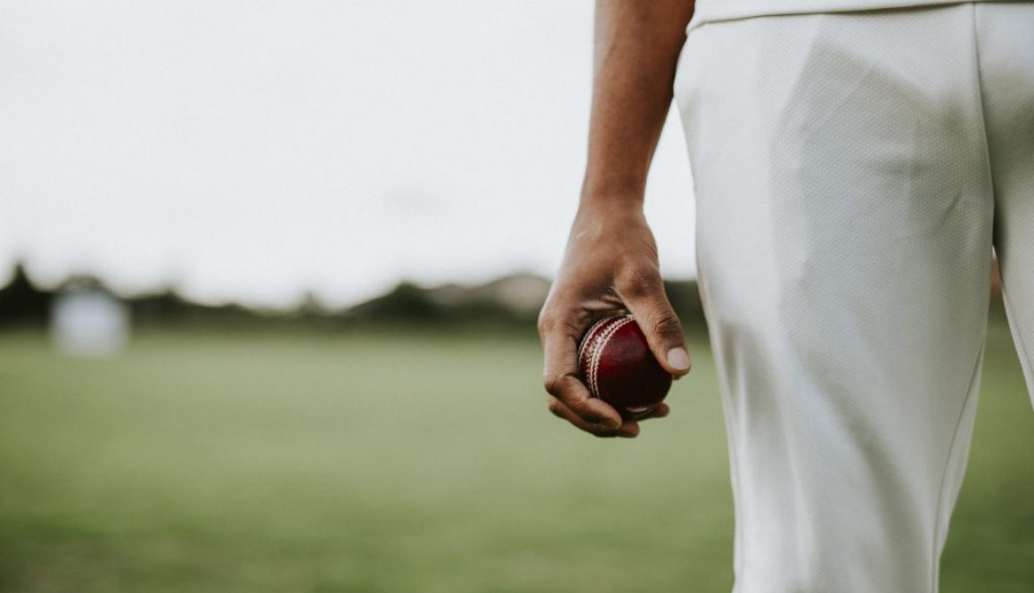 Cricket player holding a leather ball