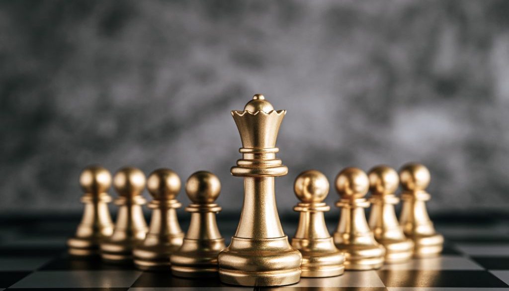 Gold Chess on chess board game for business metaphor leadership