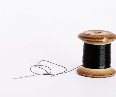 black thread on a wooden spool